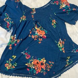 Dark blue off the shoulder shirt with floral design. Brand: Eye Shadow. Large.